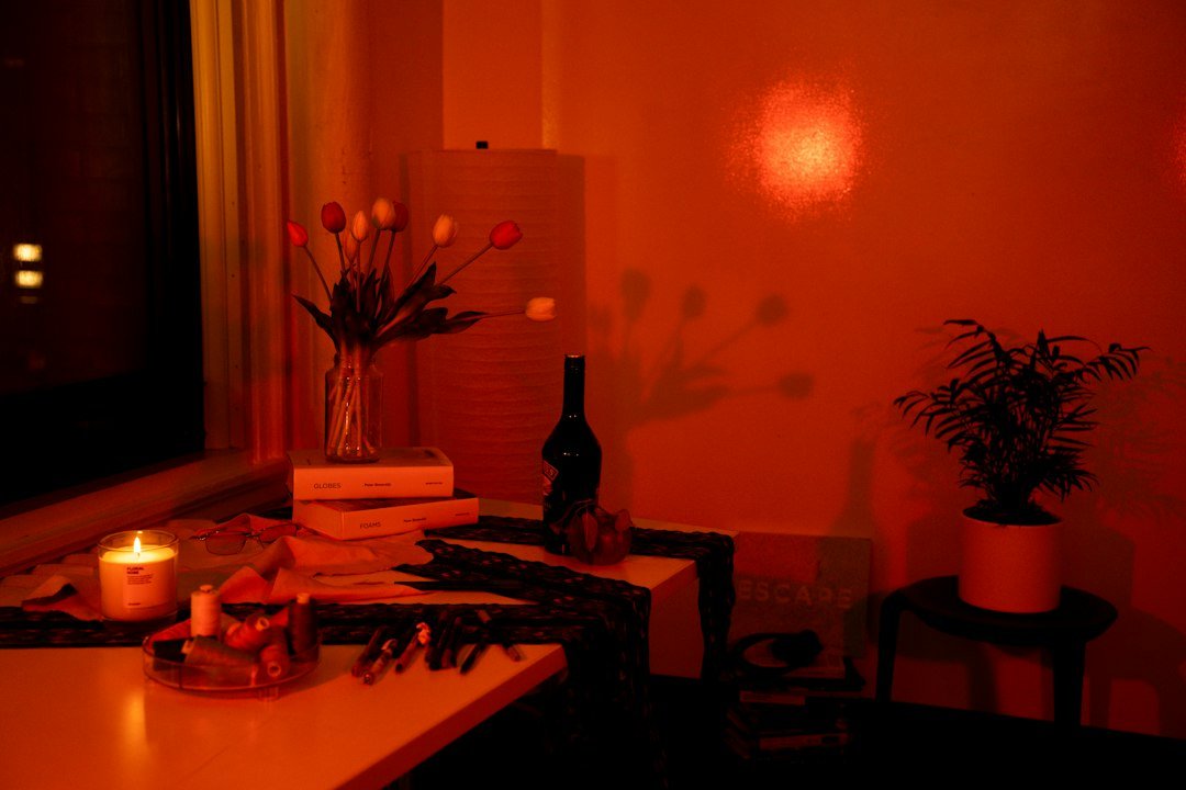 Candlelit table with flowers and greenery