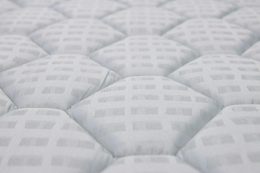 Close-up of a white quilted mattress surface